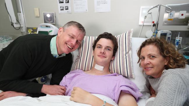 Conor Tweedy, pictured in hospital with dad Sean and mum Beck, suffered a serious spinal injury just two weeks ago. Picture: Annette Dew