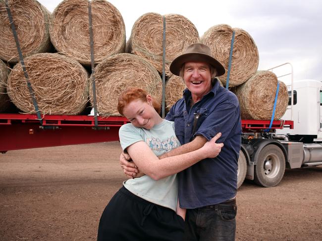 Lillie Jones with her dad Les after hay bales were trucked in from Victoria after members of the public donated to The Daily Telegraph and Sunday Telegraph’s drought appeal. Picture: Sam Ruttyn