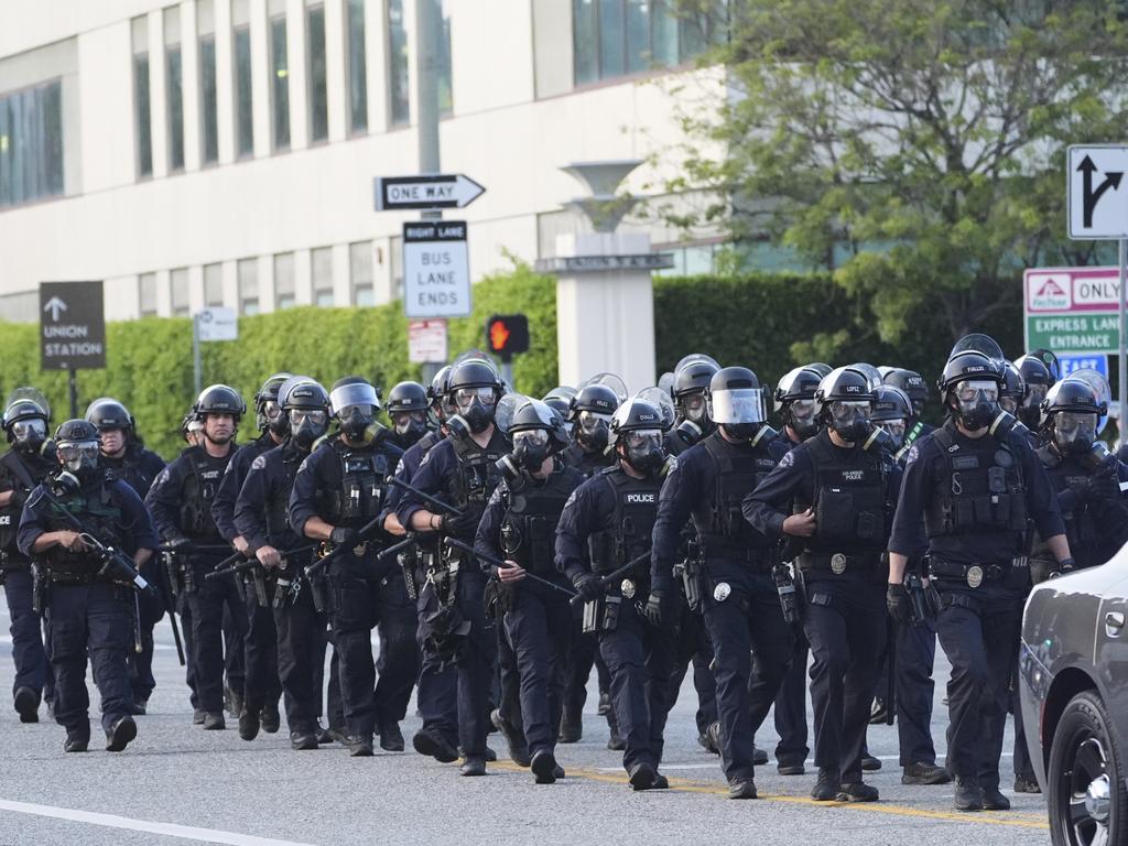 Los Angeles Police officers gather during a protest after federal immigration authorities conducted an operation. Picture: AP