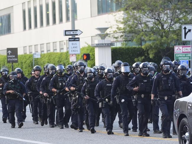Los Angeles Police officers gather during a protest after federal immigration authorities conducted an operation. Picture: AP