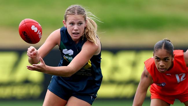 MELBOURNE, AUSTRALIA - APRIL 20: Sophie Eaton of the AFL National Academy handballs under pressure from Sienna Gerardi of the All-Stars during the Marsh AFL National Academy match between the AFL National Academy Girls and the All-Stars at RSEA Park on April 20, 2025 in Melbourne, Australia. (Photo by Josh Chadwick/AFL Photos/via Getty Images)