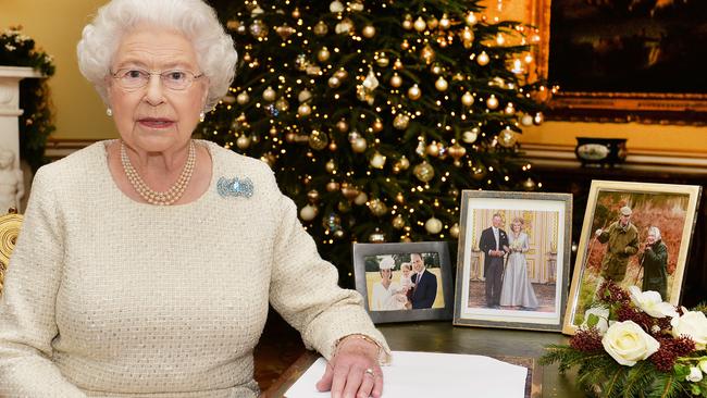 LONDON, ENGLAND - DECEMBER 25: Queen Elizabeth II sits at a desk in the 18th Century Room at Buckingham Palace, after recording her Christmas Day broadcast to the Commonwealth on December 25, 2015 in London, England. (Photo by John Stillwell-WPA Pool/Getty Images)