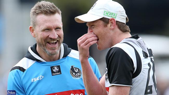 Collingwood open training session at Olympic Park.  Collingwood coach Nathan Buckley has a laugh at the expense off Nathan Murphy after he copped one in the nose during training . Pic: Michael Klein