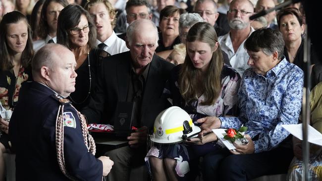 NSW Fire Commissioner Shane Fitzsimmons comforts Sam’s family. Picture: AAP