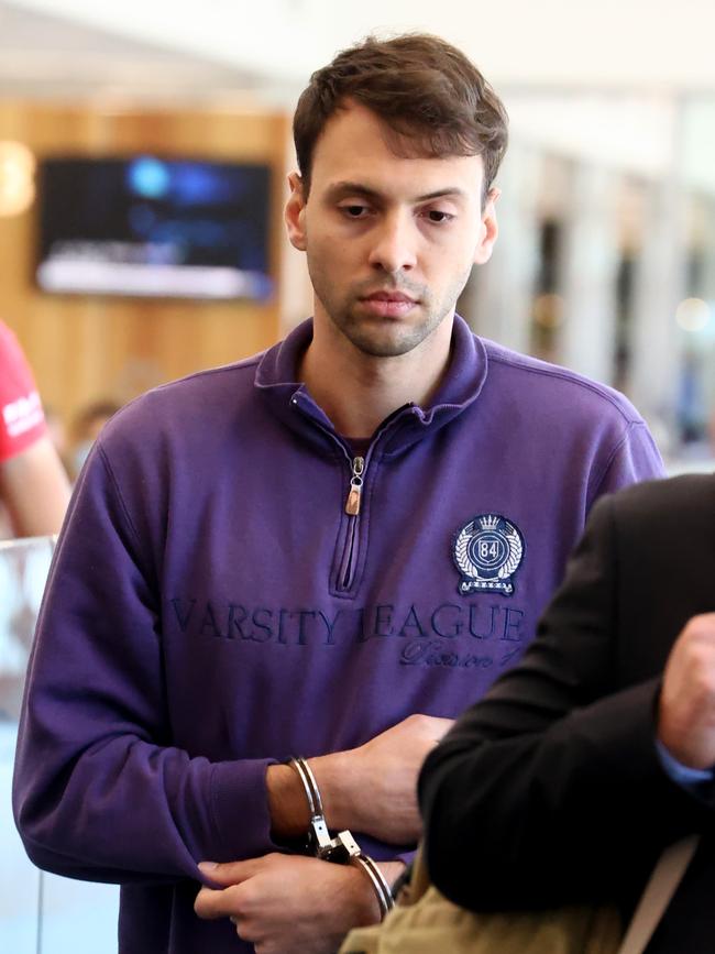 Zacharia Josef Bruckner arrives at the Adelaide Airport with police after being extradited from Queensland. Picture: NCA NewsWire / Kelly Barnes