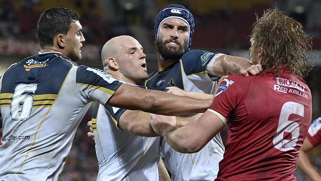 Eddie Quirk (right) of the Reds reacts after being punched by Stephen Moore.