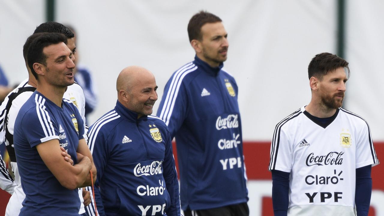 Argentina's forward Lionel Messi (R) stands next to Argentina's coach Jorge Sampaoli (2nd L) and staff members during a training session