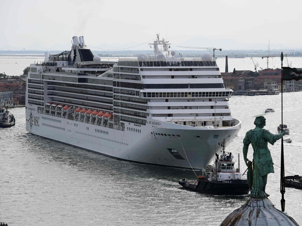 Three tugboats guide a huge ship, the MSC Magnifica into port. Picture: Miguel MEDINA / AFP.