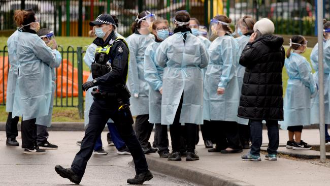 Dozens of workers put on their PPE before heading into locked down towers. Picture: Andrew Henshaw