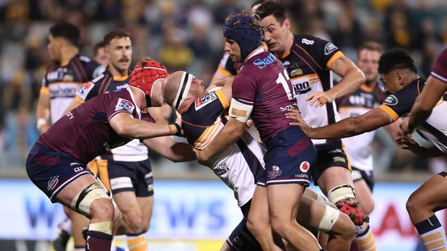 Lachlan McCaffrey is tackled during the Super Rugby AU Grand Final.