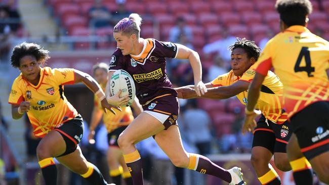 Julia Robinson of the Broncos (right) is tackled by Ruan Sims of the  Roosters during the