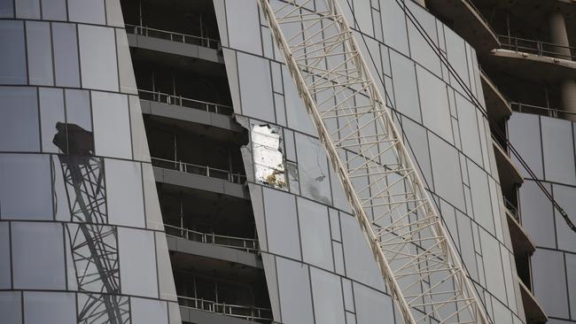 A pane of glass is ripped off by the crane hook. Picture: Christian Gilles