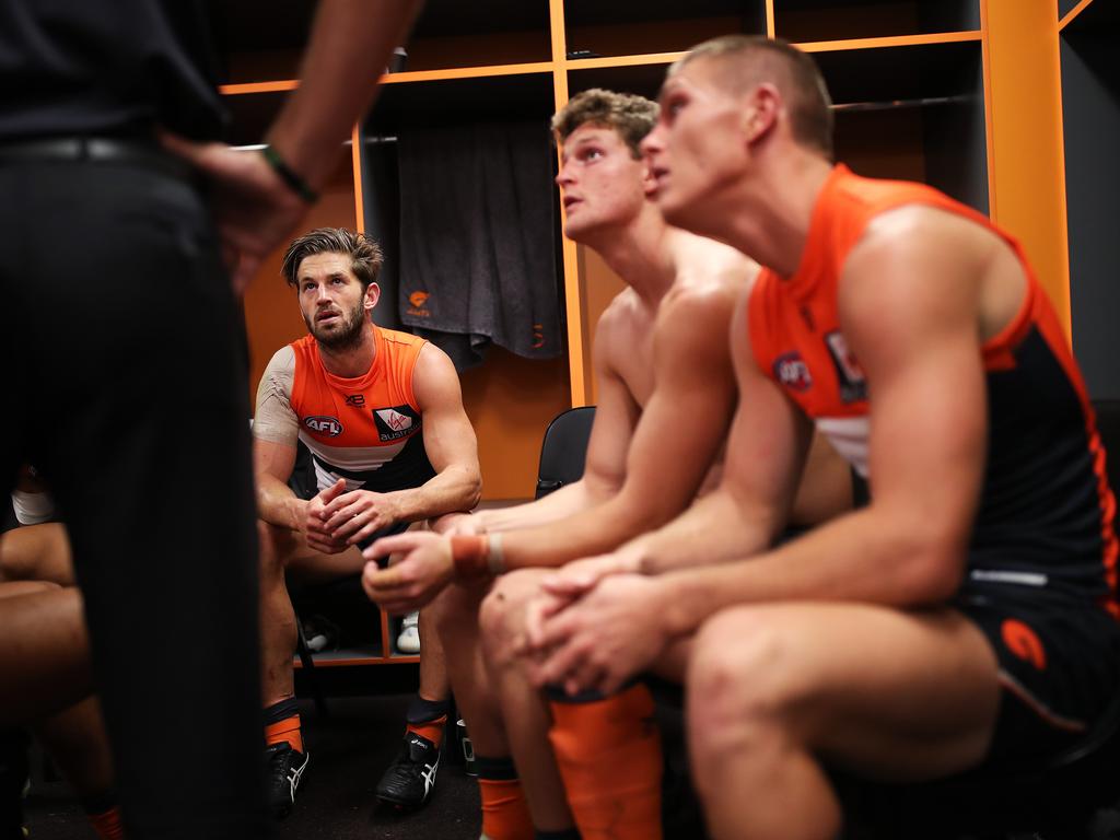 Half time and midfielders come together in a group to review the first half. Picture: Phil Hillyard