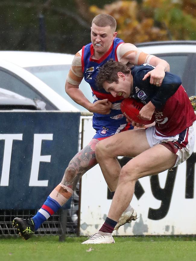 Gisborne’s Jack Scanlon lays a tackle on Sandhurst’s Lachlan Wright.