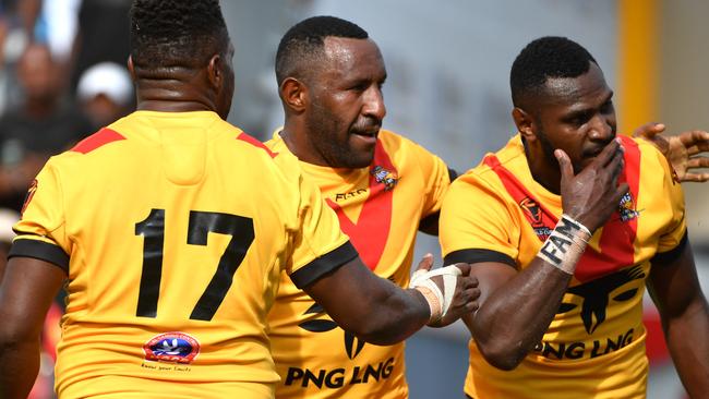 Papua New Guinea's Enock Maki (right) celebrates after scoring a try.