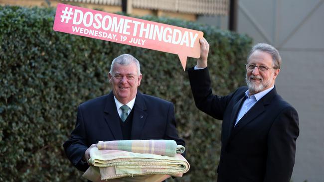 Guardian Funerals location manager Greg Baxter and St Vincent de Paul Society executive officer Graeme Roche in Bankstown with some of the blankets collected for Vinnies. Picture: Angelo Velardo