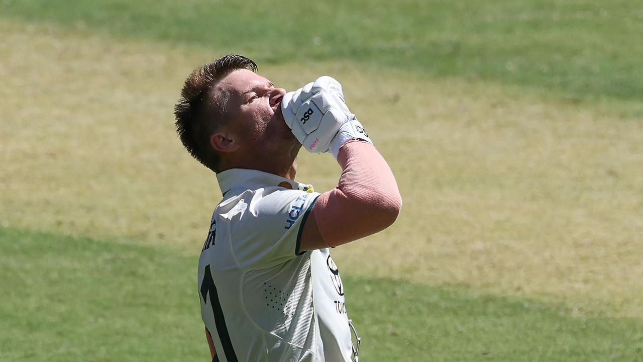 Warner delivers his one-finger celebration. (Photo by COLIN MURTY / AFP)