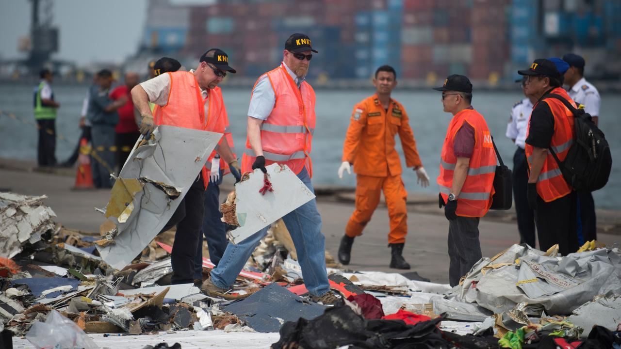 Officials from the US National Transportation Safety Board examine recovered debris from the ill-fated Lion Air flight JT 610 at a port in Jakarta on November 1, 2018. Picture: Bay Ismoyo/AFP.