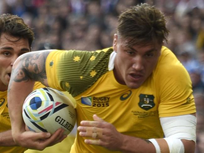 Australia's flanker Sean McMahon (R) runs in Australia's first try during the Pool A match of the 2015 Rugby World Cup between Australia and Uruguay at Villa Park in Birmingham, north England on September 27, 2015. AFP PHOTO / MARTIN BUREAU RESTRICTED TO EDITORIAL USE, NO USE IN LIVE MATCH TRACKING SERVICES, TO BE USED AS NON-SEQUENTIAL STILLS