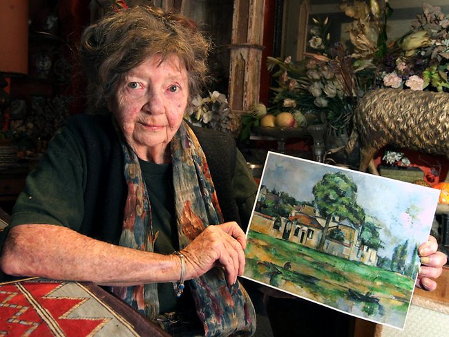 <p>Artist Margaret Olley with a copy of a $14 million Paul Cezanne painting titled 'Bords de la Marne' circa 1888, which she wanted the Art Gallery of NSW to buy for the people of NSW. Picture: Noel Kessel</p>