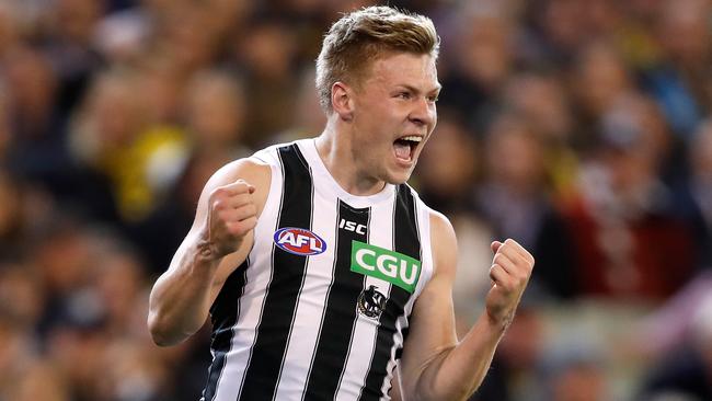 Jordan De Goey celebrates a goal for the Magpies against Alex Rance. Picture: Getty Images