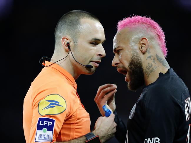 PSG's Neymar talks with French referee Jerome Brisard during the French League One soccer match between Paris-Saint-Germain and Montpellier at the Parc des Princes stadium in Paris, Saturday Feb. 1, 2020. (AP Photo/Christophe Ena)