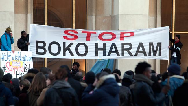 Men hold a banner during a gathering at the Trocadero place, in Paris, Sunday, Jan. 18, 2015 to protest against extremist Islamic group Boko Haram after a large-scale attack in Baga, where as many as 2,000 people were massacred in a raid on January 7, 2015. Cameroon, Chad and Niger have launched a regional bid to combat the Boko Haram. (AP Photo/Thibault Camus)