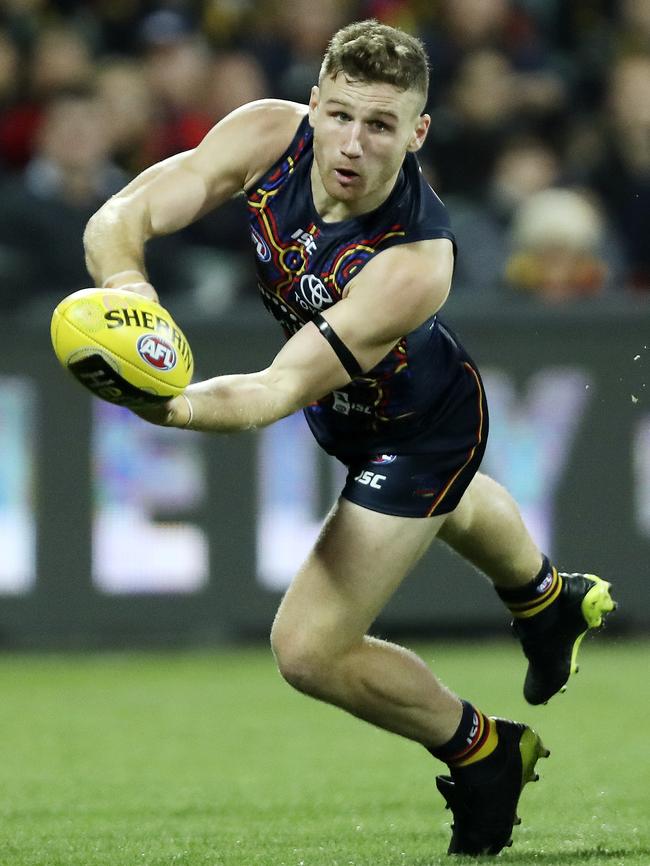 Adelaide’s Rory Laird fires out the handball.  Picture Sarah Reed