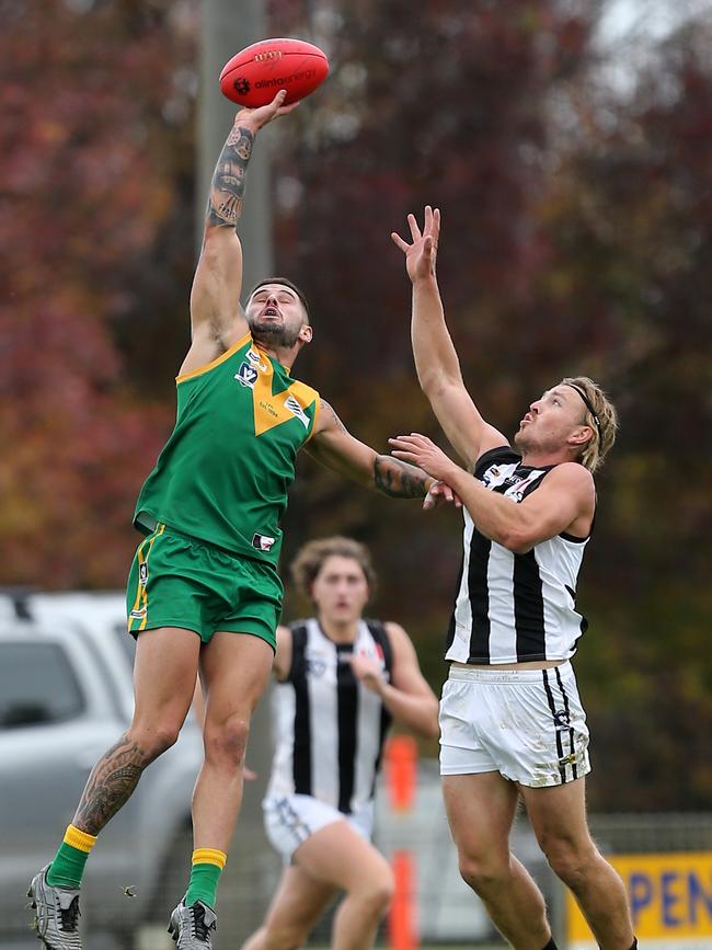 Leongatha’s Tallin Brill soars over Sale’s Lachie Ronchi. Picture: Yuri Kouzmin