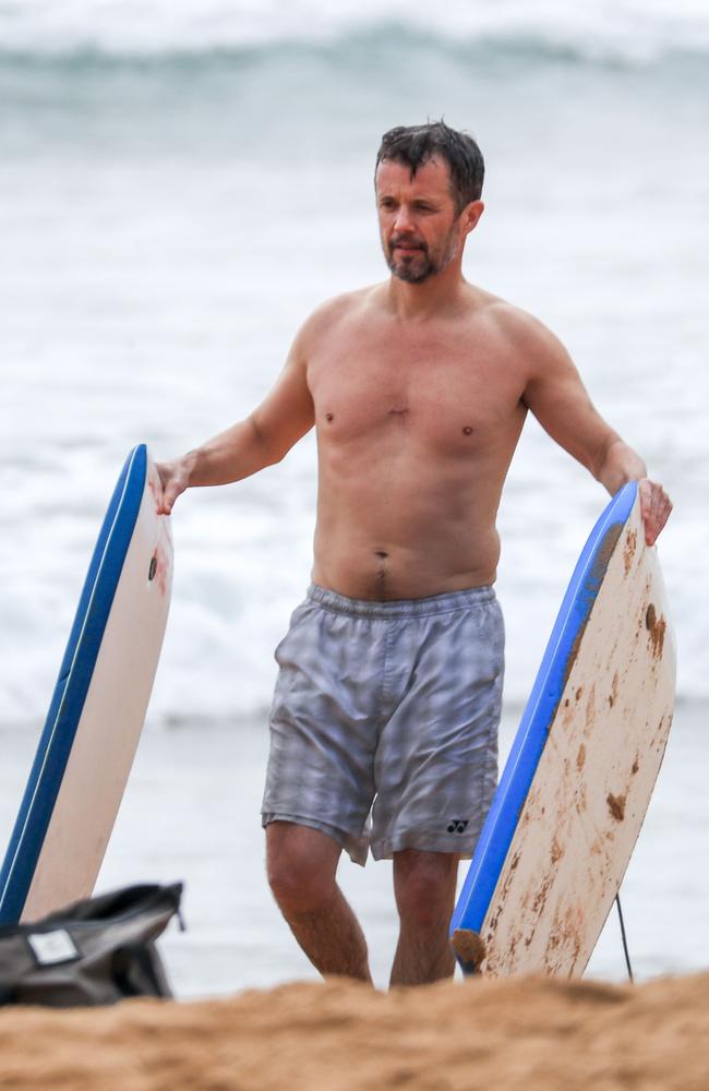 Fred helps the kids out with their boogie boards. Princess Mary and her royal family hit Sydney’s Palm Beach for a dip before they head to Tasmania for an Aussie Christmas. Picture: Media Mode
