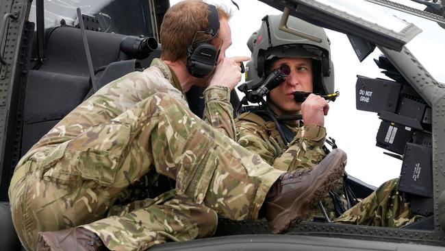 Prince William receives advice as he sits in the cockpit of an Apache helicopter. Picture: AFP