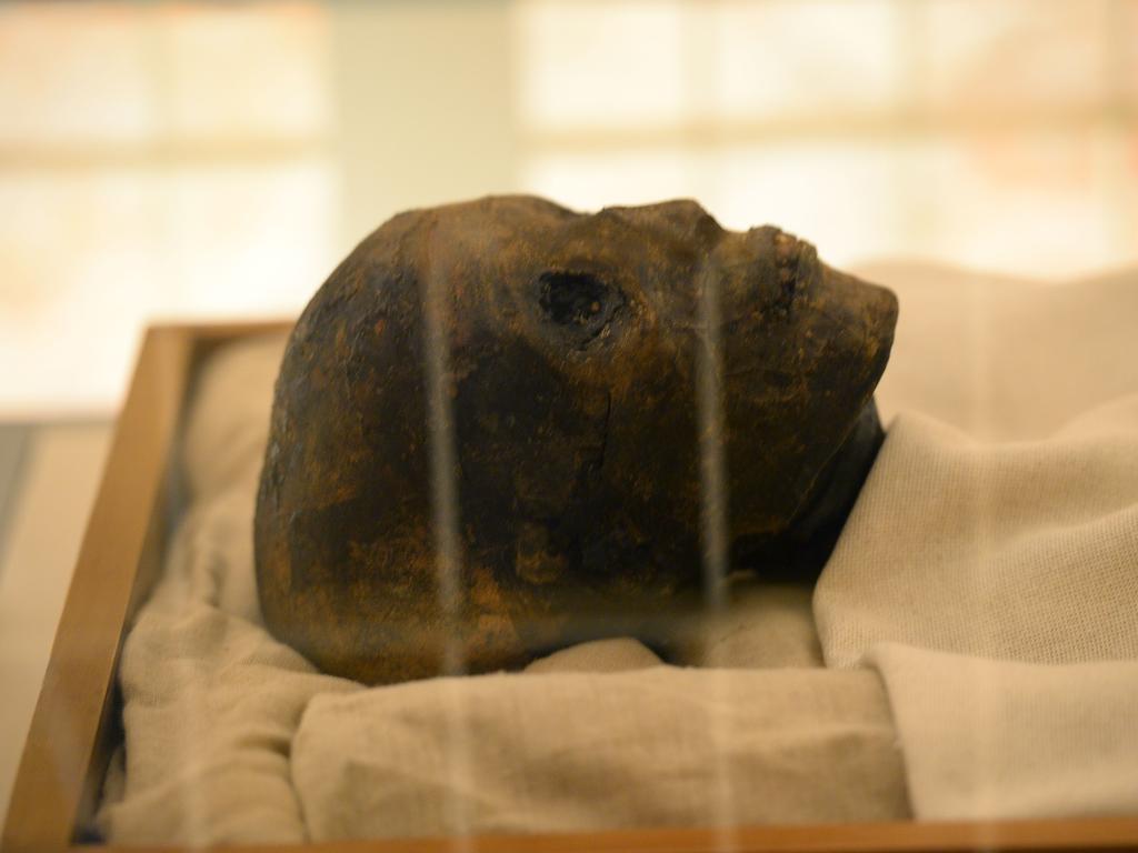 The head of the linen-wrapped mummy of Tutankhamun displayed in his climate-controlled glass case in his underground tomb Picture: AFP