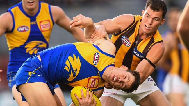 Eagle Jack Redden is tackled by Hawthorn’s Jaeger O'Meara. Picture: Daniel Carson/AFL Photos via Getty Images