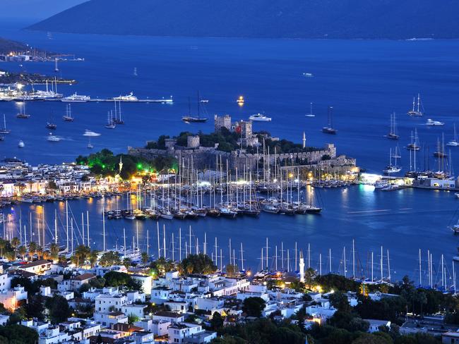 View of Bodrum harbour and Castle of St. Peter after sunset. Turkish Riviera.