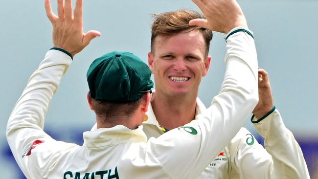 Australia's Matthew Kuhnemann (back) celebrates with his captain Steve Smith after taking the wicket of Sri Lanka's Kamindu Mendis during the fourth day of the first Test cricket match between Sri Lanka and Australia at the Galle International Cricket Stadium in Galle on February 1, 2025. (Photo by Ishara S. KODIKARA / AFP)