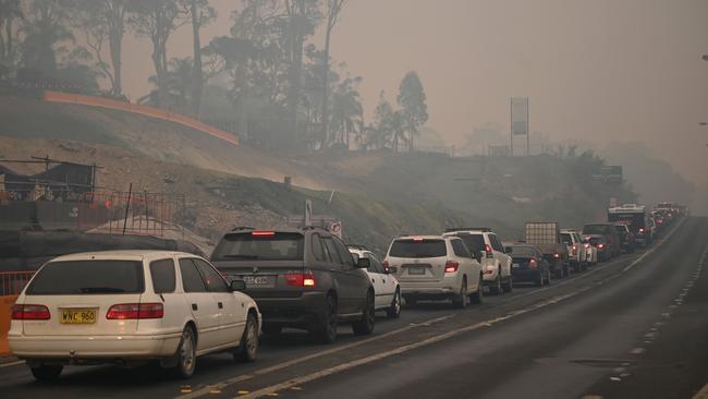 Cars line up to leave the town of Batemans Bay in New South Wales to head north on Thursday. Picture: Peter Parks/AFP