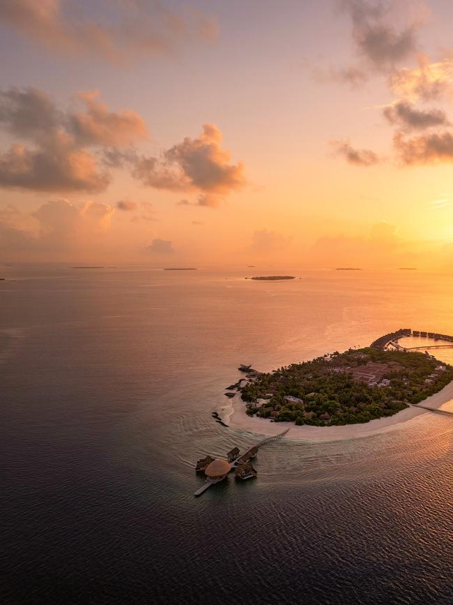 The sublime island of Bodufushi sparkles at sunset in Raa Atoll.