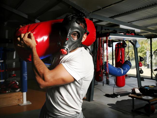 The man known only as Jimmy, who would get Lloyd out of bed at all hours to physically and mentally train him, wearing an oxygen mask. Picture: Colleen Petch