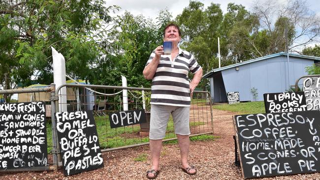 Fran Hodgetts with signs displaying her tea shop’s fare.