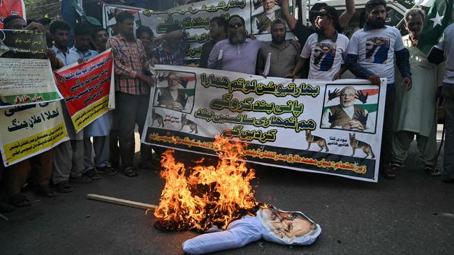 Traders shout slogans and burn effigy of India’s Prime Minister. Picture: Rizwan TABASSUM / AFP