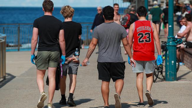 Waverley College Year 12 students on litter duty at Bronte Beach today. Picture: Justin Lloyd