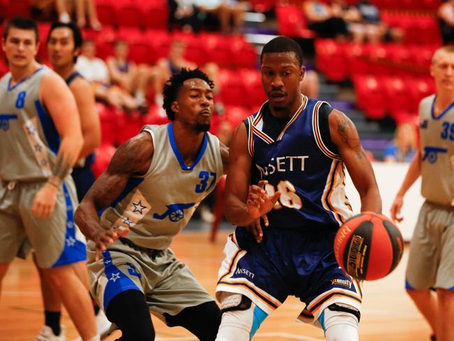 Cannons star Raymond Jarrett (left) takes on Ansett’s Fred Williams. Picture: Glenn Campbell