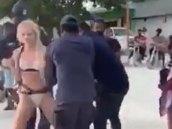 Picture four in a sequence of seven. Screengrab from video taken with permission from the Twitter feed of @MvCrisis which shows a tourist in a bikini being detained by at least three officers on the island of Maafushi, in the Kaafu atoll.. Issue date: Friday February 7, 2020. According to local news reports the woman was arrested for 