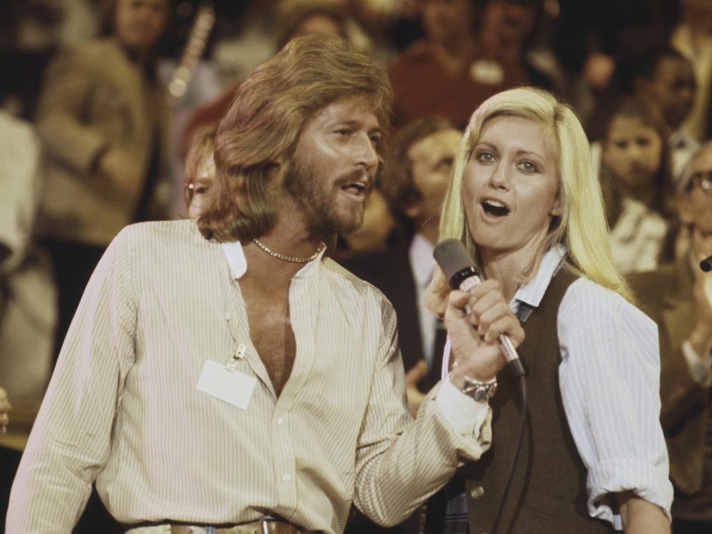 British singer Barry Gibb of The Bee Gees performs live on stage with Olivia Newton-John in 1979. Picture: Getty