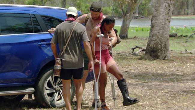 Nina is helped out of the car.