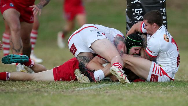 Kincumber’s Joel Sherab held up over the line. Picture: Sue Graham