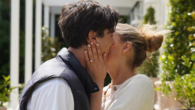 The couple announcing their engagement, showing off the classic round cut diamond in a four-claw setting from Class A Jewellers. Picture: Instagram