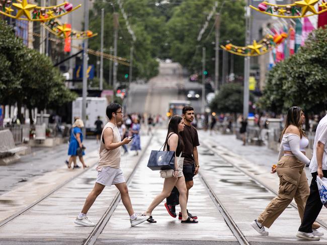 MELBOURNE, AUSTRALIA - NCA NewsWire Photos - 13 DECEMBER, 2023: People carry shopping bags while walking along Bourke Street Mall in Melbourne. Picture: NCA NewsWire / Diego Fedele