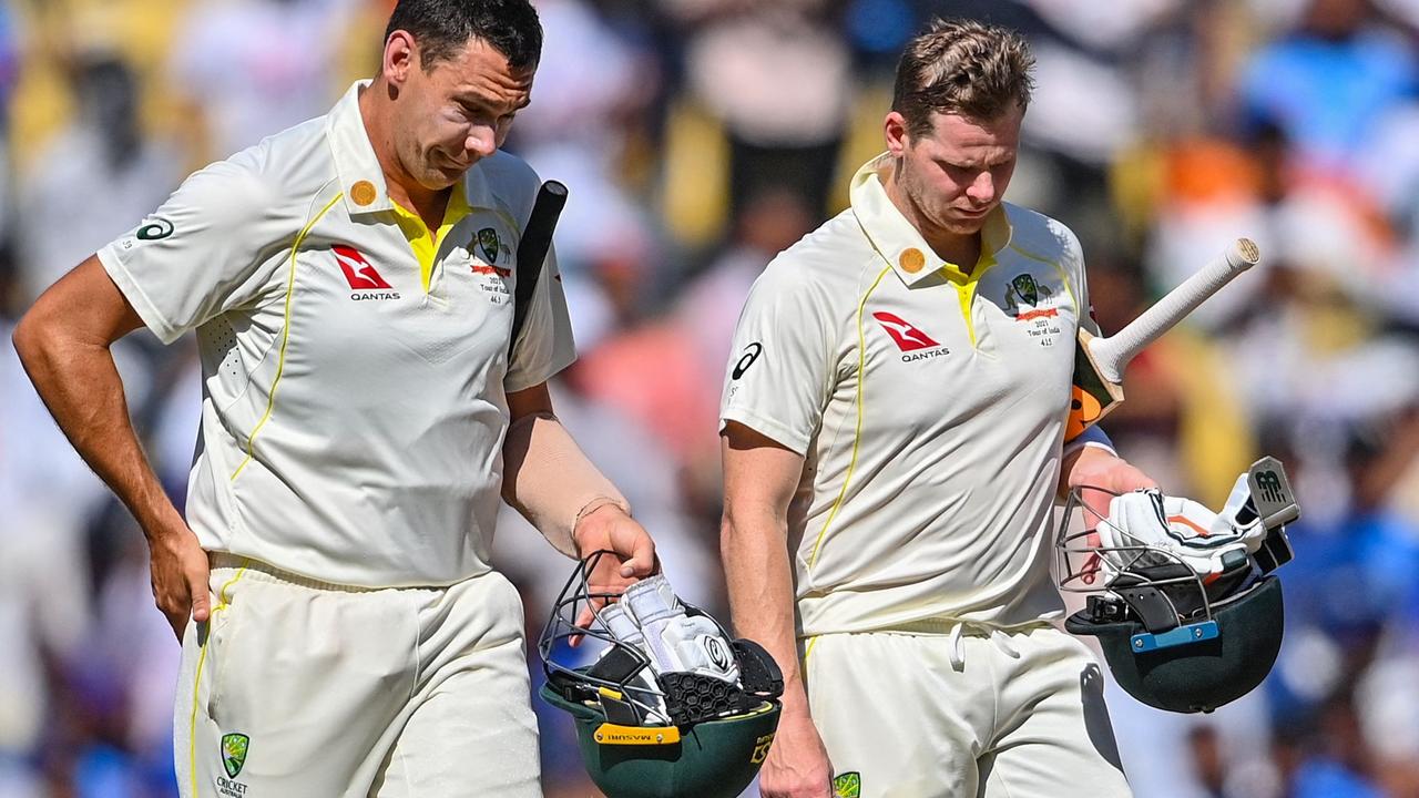 Australia's Scott Boland and Steven Smith walk off the ground after the visitors were dismissed inside a session. Picture: AFP