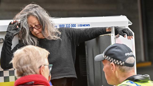 Extinction Rebellion protester Meme Thorne is arrested after disrupting Adelaide traffic by abseiling from the Morphett Street Bridge. Picture: NCA NewsWire / Brenton Edwards